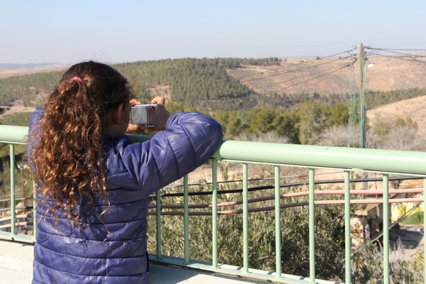 Young girl looks out over Yatir Forest in the arid Negev region. Photo: Yoav Devir, for KKL-JNF