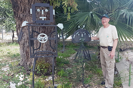 Sasha near one of his statues, created from recycled materials. Photograph: Mra Zer.
