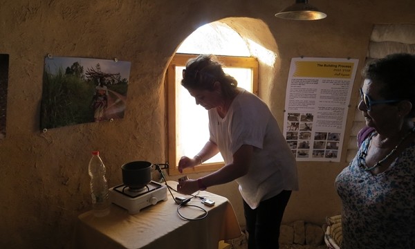 Cooking using bio-gas in the mud hut in the model off-grid village in Kibbutz Ketura. Photo: Yoav Devir