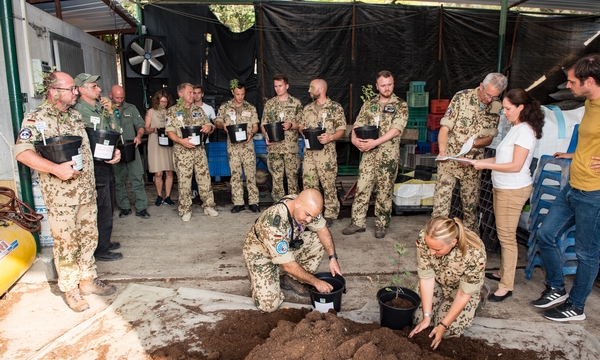 Visiting German Airforce contingent plants trees in containers, instead of in the ground. Photo: Dennis Zinn